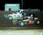Jon Johnson and Darrell Jennings drive past the turn 3 shack at Wichita Falls